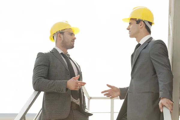 Engineers discussing on stairway — Stock Photo, Image