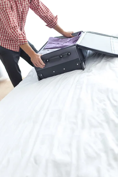 Businessman packing suitcase — Stock Photo, Image