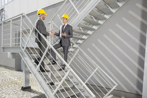 Engineers discussing on steps — Stock Photo, Image