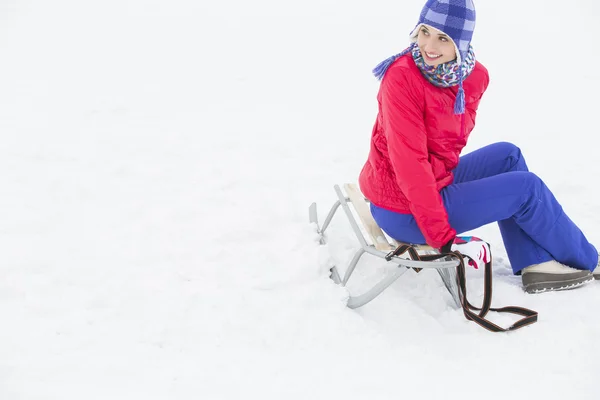 Frau sitzt auf Schlitten — Stockfoto