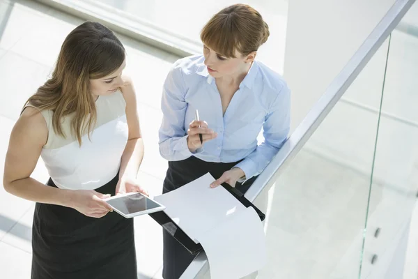 Businesswomen discussing over tablet PC — Stock Photo, Image