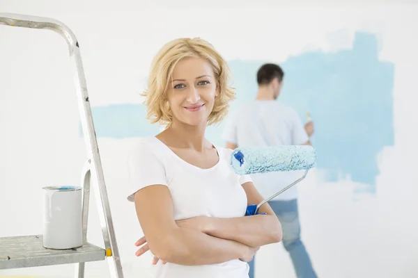 Woman holding paint roller — Stock Photo, Image