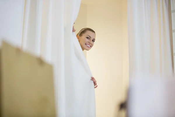 Woman is hiding behind curtains — Stock Photo, Image