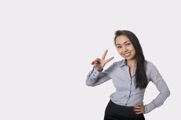 Businesswoman showing victory sign — Stock Photo, Image