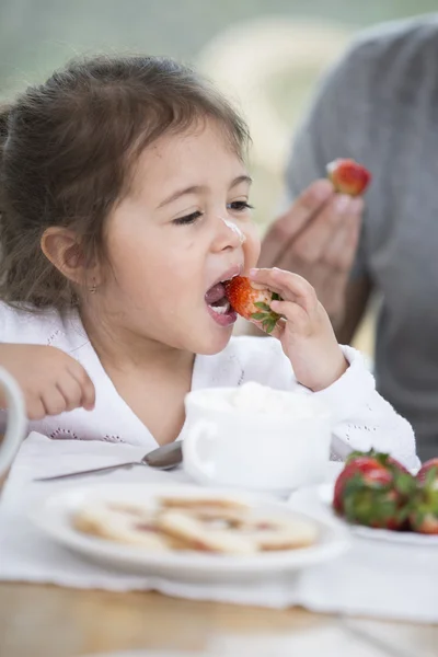 Little girl eating strawberries — Stock Photo, Image