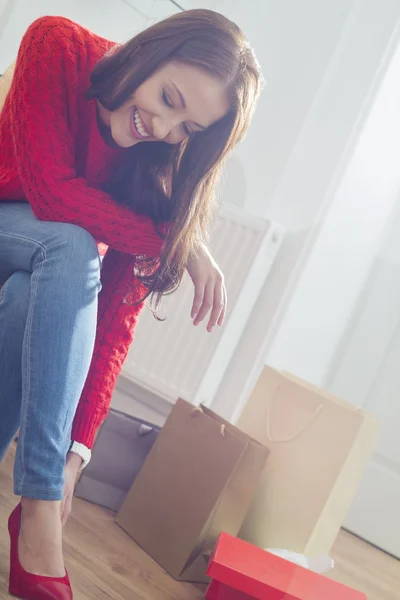 Woman trying on footwear in store — Stock Photo, Image