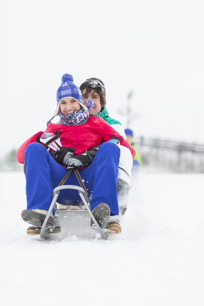 Couple enjoying sled ride — Stock Photo, Image