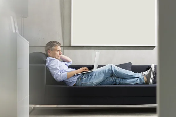 Middle-aged man using laptop — Stock Photo, Image