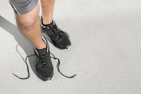 Man with untied shoelace — Stock Photo, Image