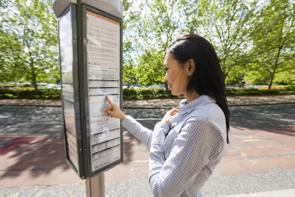 Businesswoman reading information sign — Stock Photo, Image