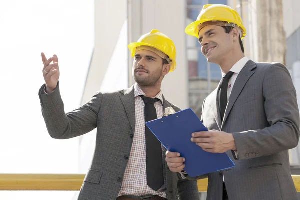 Arquitetos com área de transferência discutindo — Fotografia de Stock