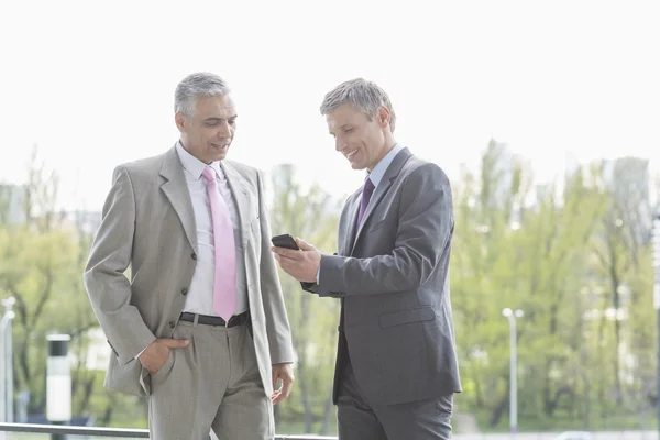 Businessmen using cell phone — Stock Photo, Image