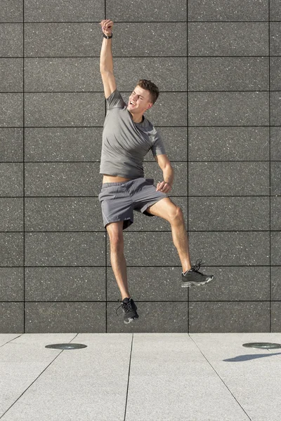 Jogger jumping against wall — Stock Photo, Image