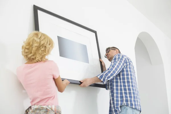 Couple hanging picture frame — Stock Photo, Image