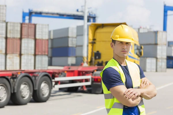 Man standing in shipping yard Stock Photo