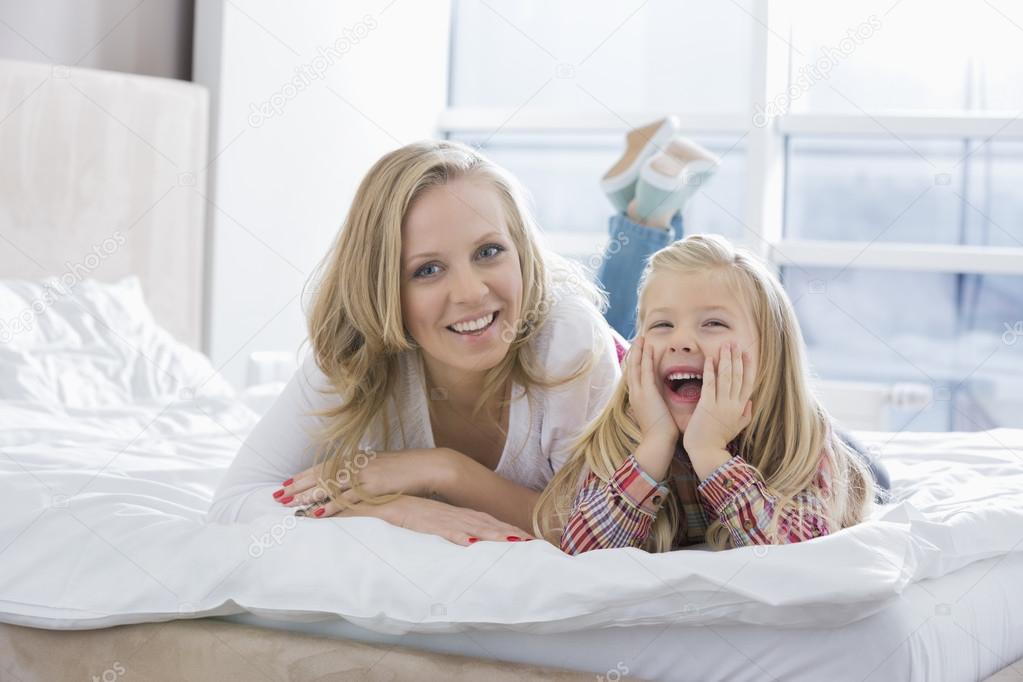 mother and daughter lying in bed