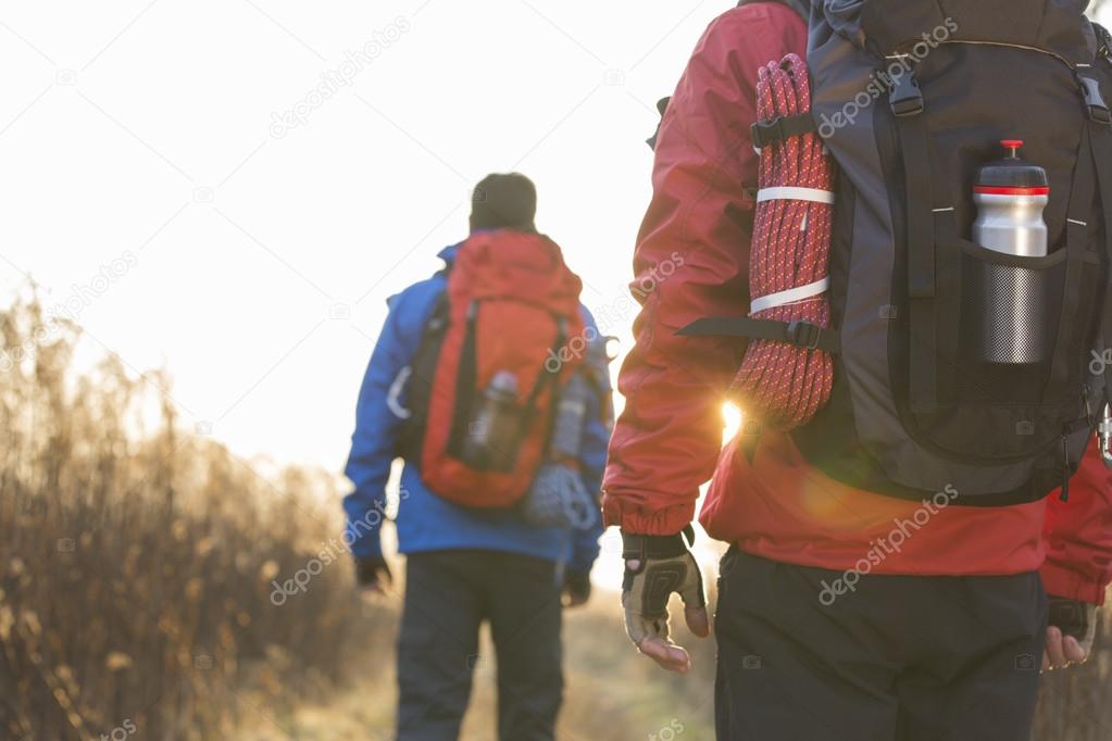 Backpackers walking in field