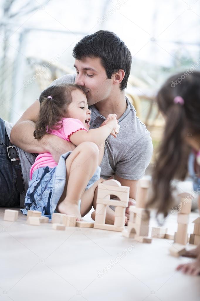 Loving father kissing daughter