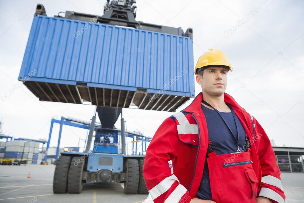 Worker standing in front of freight vehicle