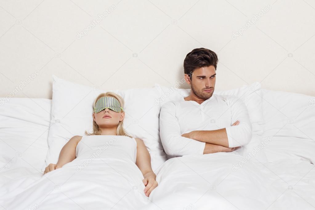 Man with woman sleeping in bed