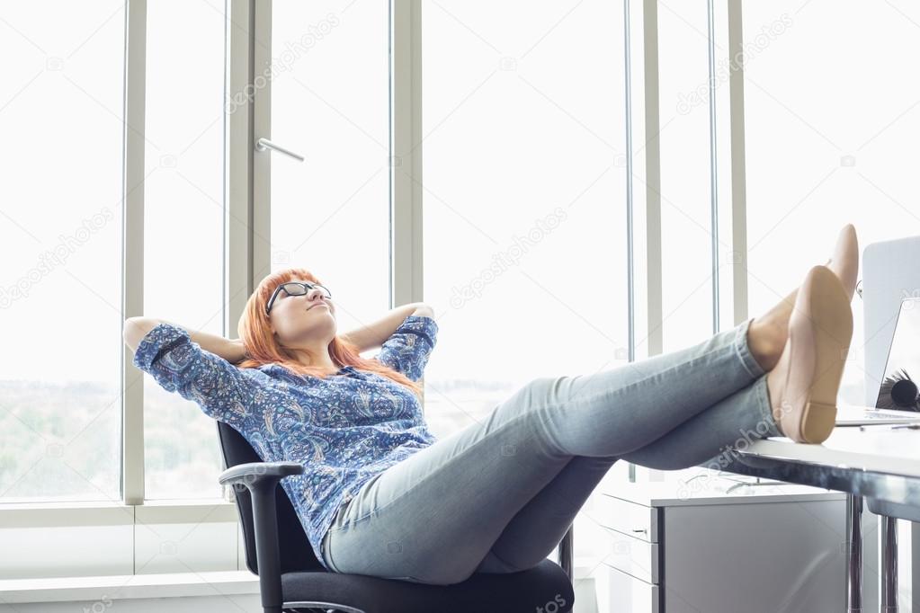 Businesswoman relaxing with feet up