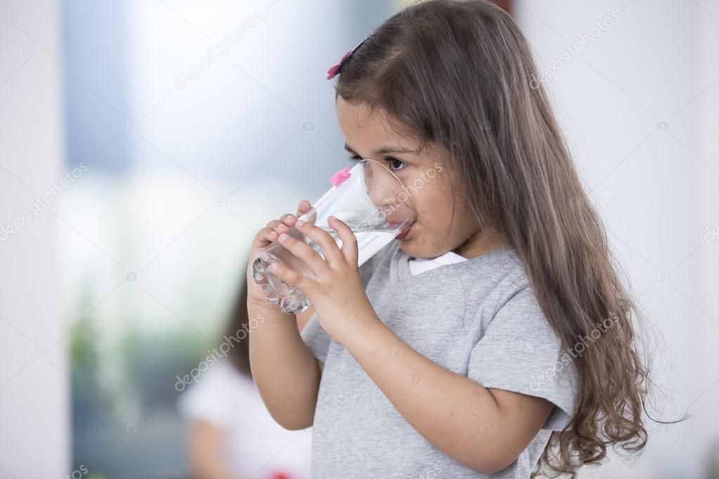 Cute girl drinking water