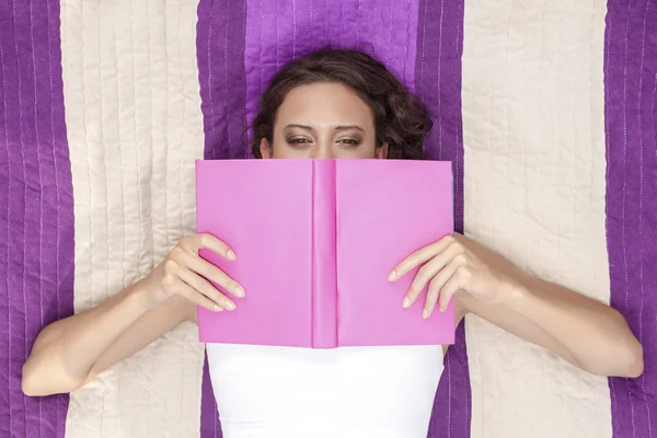 Frau bedeckt Gesicht mit Buch — Stockfoto