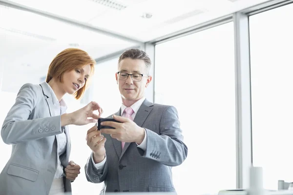 Businessman and businesswoman using cell people