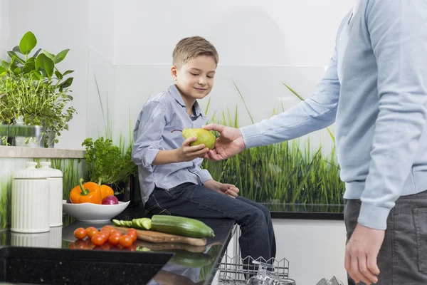 Father giving pear to son — Stock Photo, Image