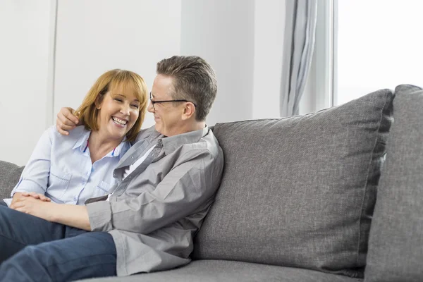 Loving couple sitting on sofa — Stock Photo, Image