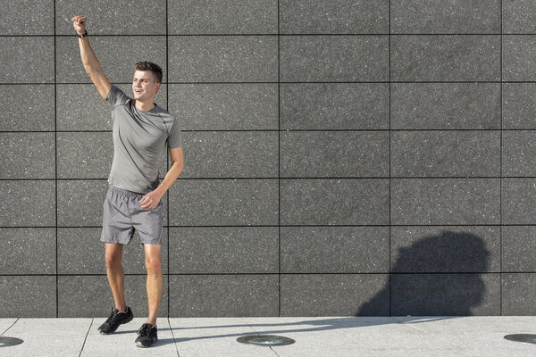 Jogger standing against wall