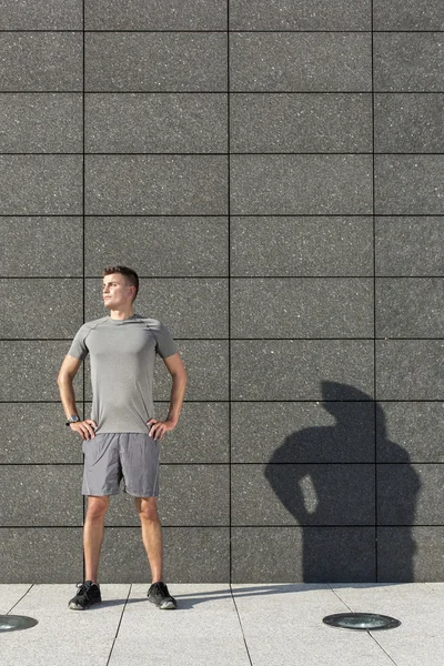 Jogger standing with hands on hips — Stock Photo, Image