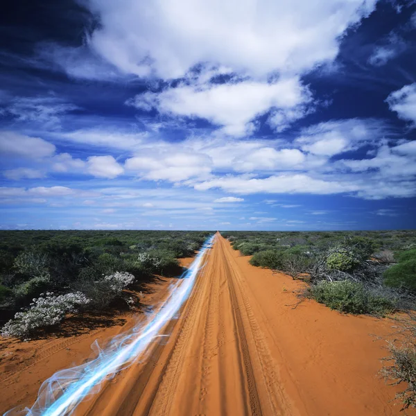 Streak of light on dirt road — Stock Photo, Image