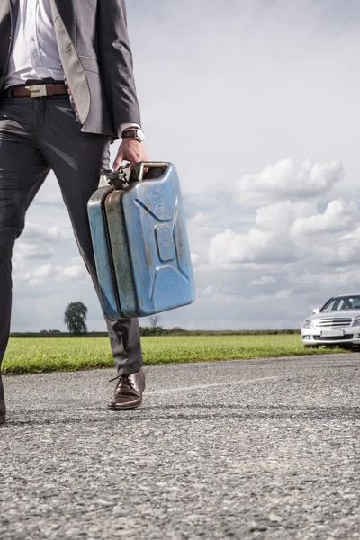 Businessman carrying gas can — Stock Photo, Image