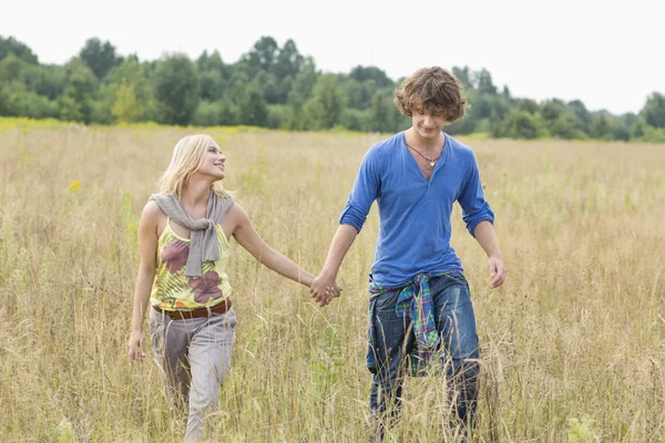 Couple holding hands while walking — Stock Photo, Image