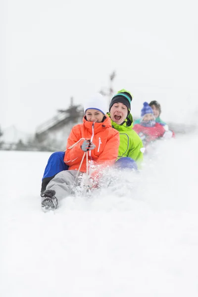 Young friends sledding — Stock Photo, Image