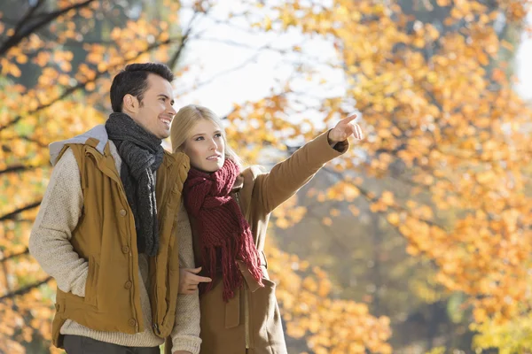 Woman pointing while standing — Stock Photo, Image