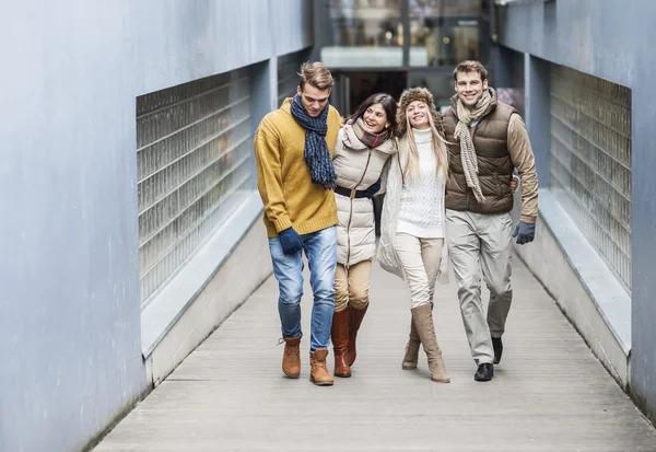 Young friends walking on walkway — Stock Photo, Image