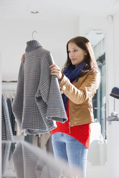 Woman selecting sweater — Stock Photo, Image