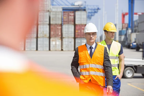 Workers walking in shipping yard Stock Image