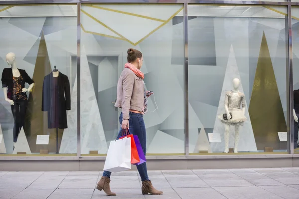 Woman looking at window display Royalty Free Stock Images