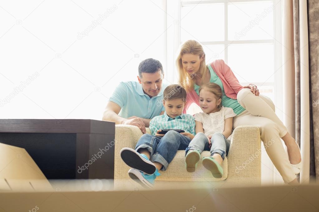 Family looking at boy playing