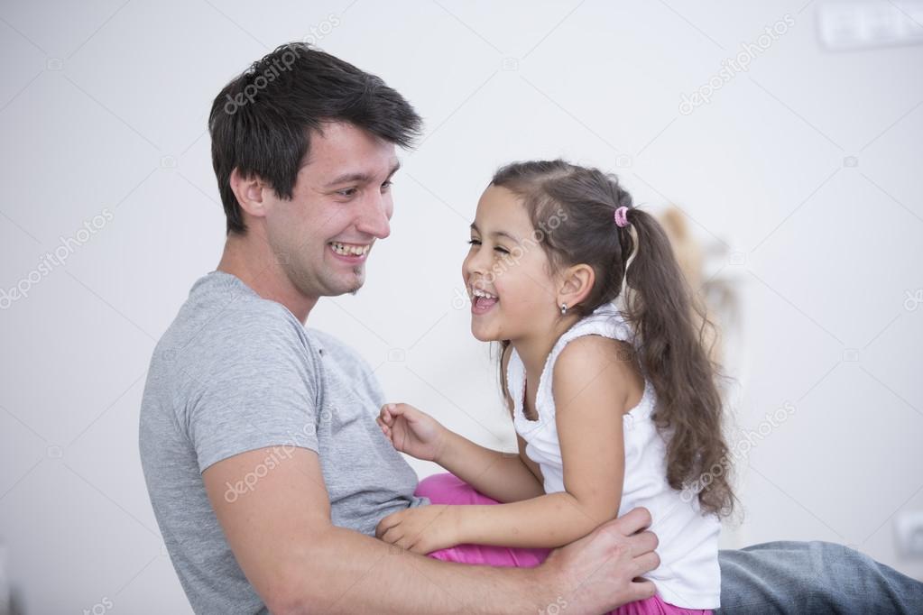 Father and daughter smiling