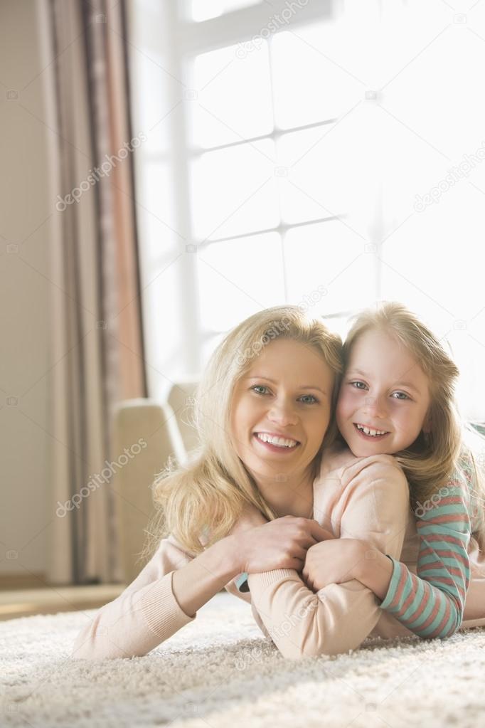 mother and daughter lying on floor