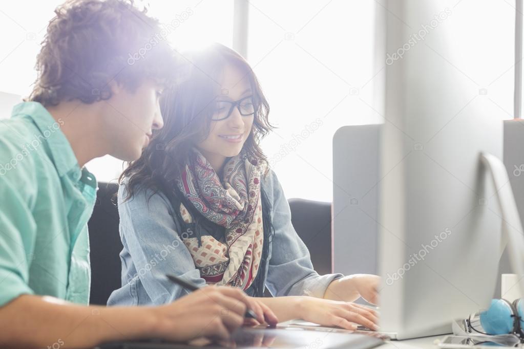 Businesspeople using desktop computer