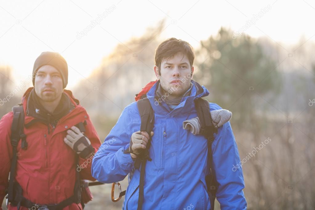hikers looking away in field
