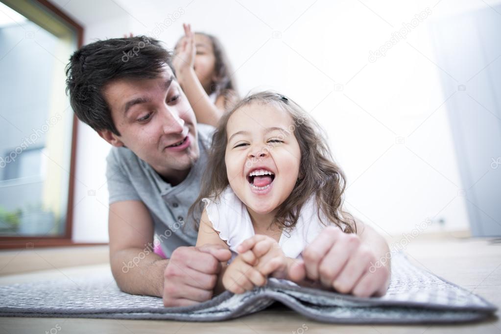 Father looking at cheerful daughter