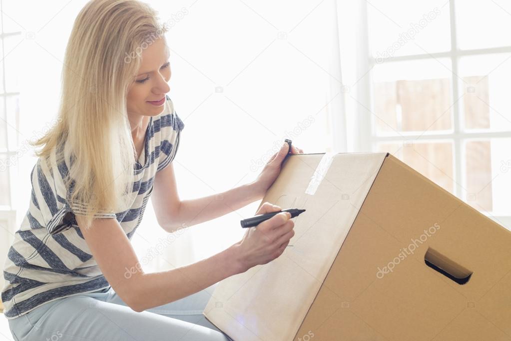 Woman labeling moving box