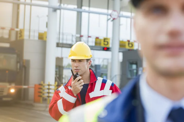 Worker using walkie-talkie with colleague — Stock Photo, Image