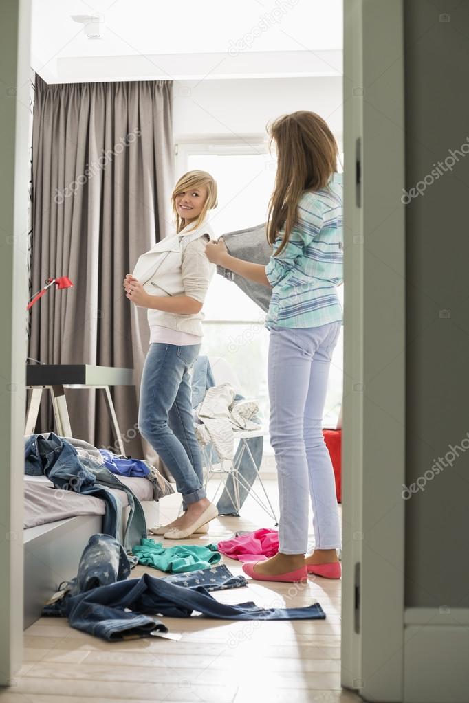 Sisters trying on clothes